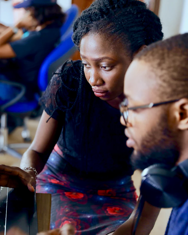 Two colleagues working together at a computer