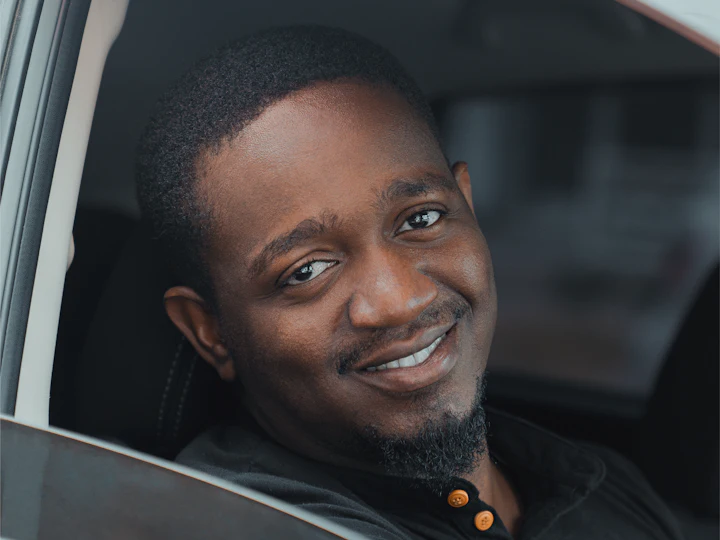 A smiling car owner in the driver’s seat