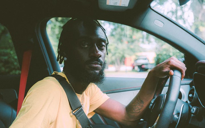 A man at the wheel of his car